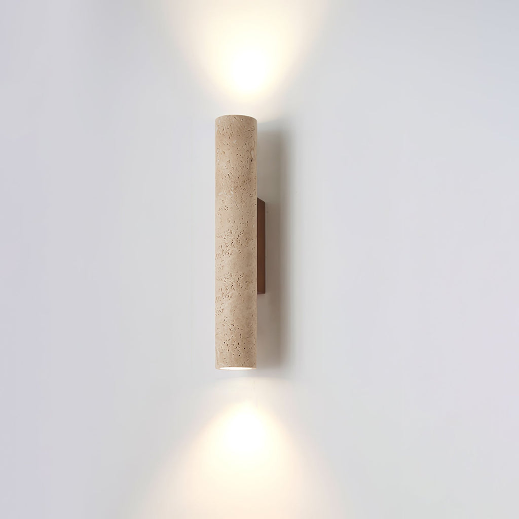 The shorter version of this Clérachic wall light glows lit, its walnut mount to one side.