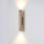 The shorter version of this Clérachic wall light glows lit, its walnut mount to one side.