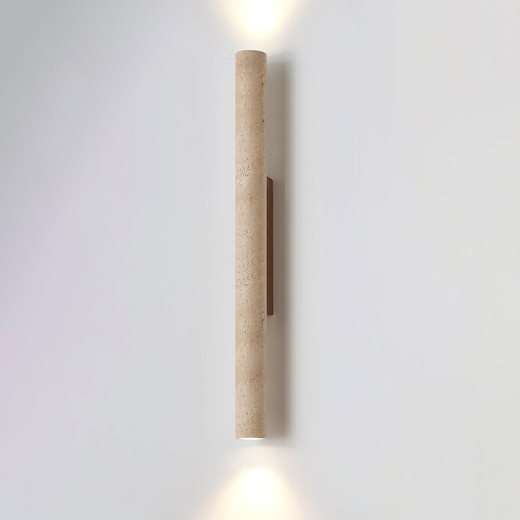 The taller version of this Clérachic wall light stands lit against a plain grey studio wall.
