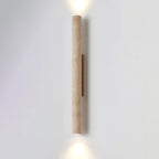 The taller version of this Clérachic wall light stands lit against a plain grey studio wall.