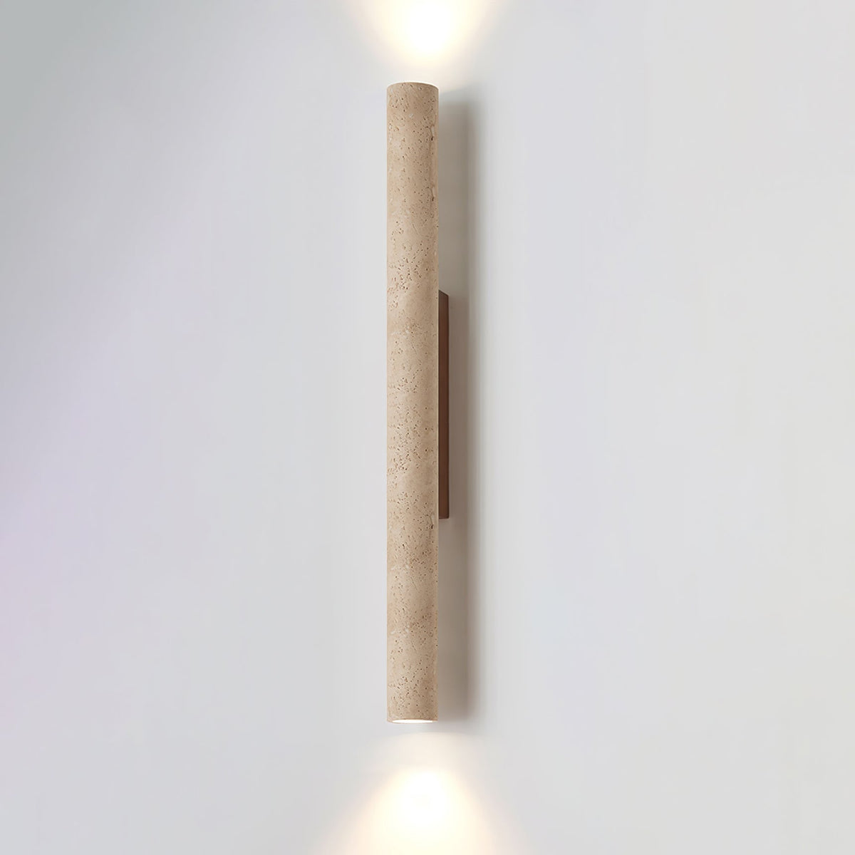 The taller version of this Clérachic wall light stands lit against a plain grey studio wall.
