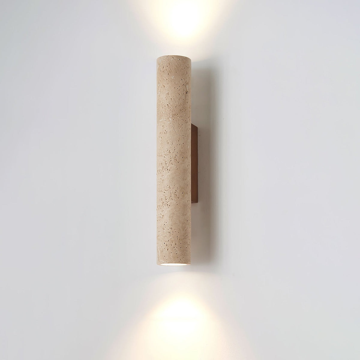 Straight-on studio shot of this Clérachic wall light, lit, against a plain grey backdrop.