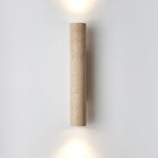 Set against a plain grey backdrop, the taller version of this Clérachic wall light glows lit.