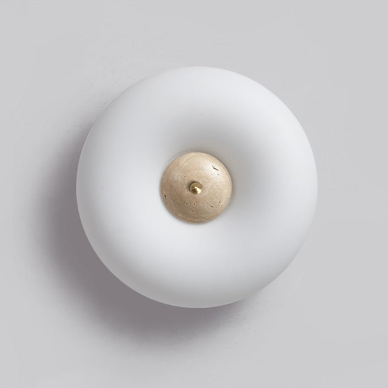 Clérachic ceiling light photographed off, from a raised angle, showing its rounded profile and brass-fitted stone centre.