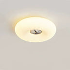 Clérachic ceiling light in a wide oval crop, its dark grey marbled stone centre glowing on a plain grey backdrop.