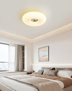 Clérachic ceiling light mounted in a taupe bedroom corner, lit beside a curtained window and a framed picture.