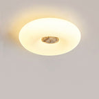 Clérachic ceiling light lit in close crop, sheer curtains and a radiator visible in the softly lit room below.