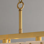 Close-up of the brass suspension rod, ring and chain above the chandelier's top rail.