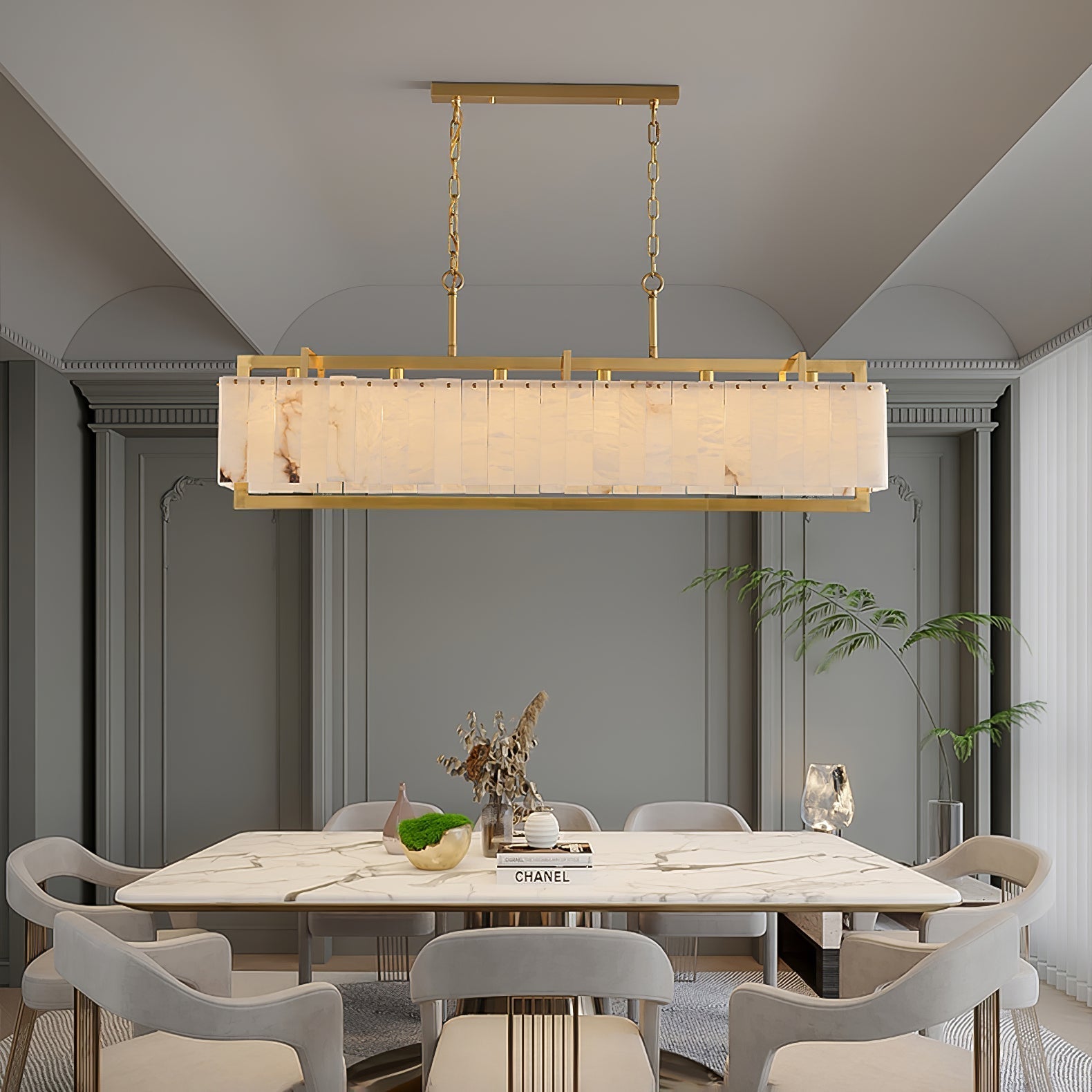 Lit above a marble table in an arched grey room, books and a plant on the table below.