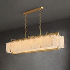 The same chandelier on dark grey, its alabaster panels lit warm within the brass cage.