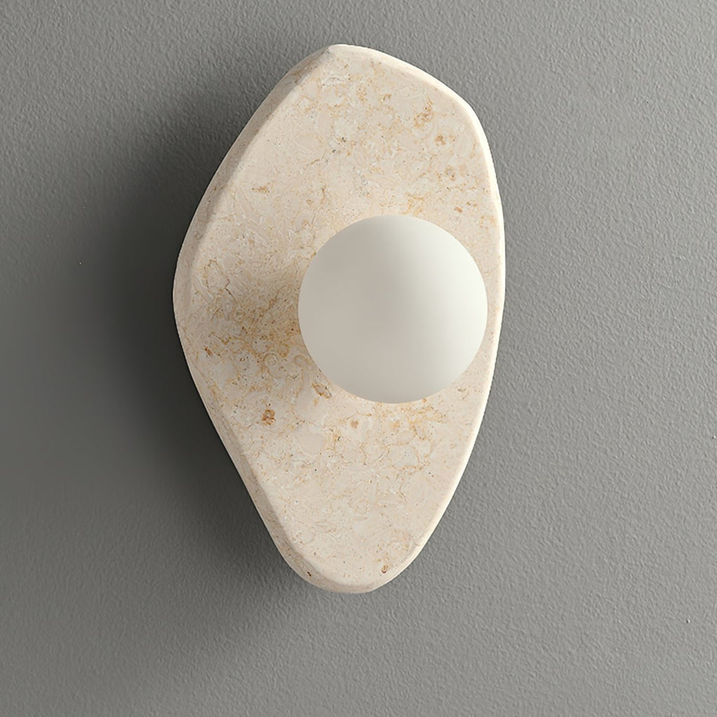 Unlit beige stone wall light from Clérachic photographed on a plain grey studio background.