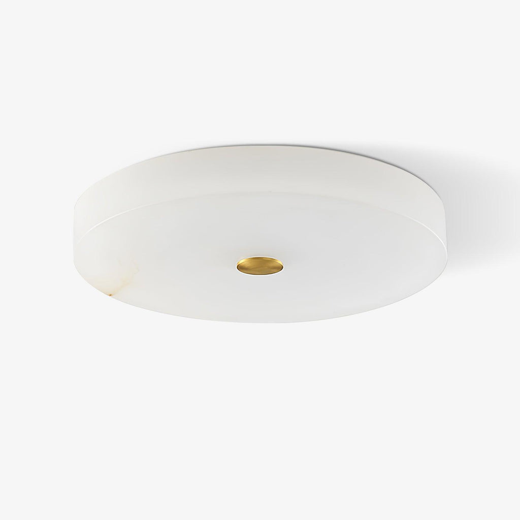 Unlit Olaean flush mount on white, brass centre cap and faint amber veining along the alabaster rim.