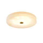 Large product shot of the Olaean flush mount lit on white, light spreading evenly across the disc.