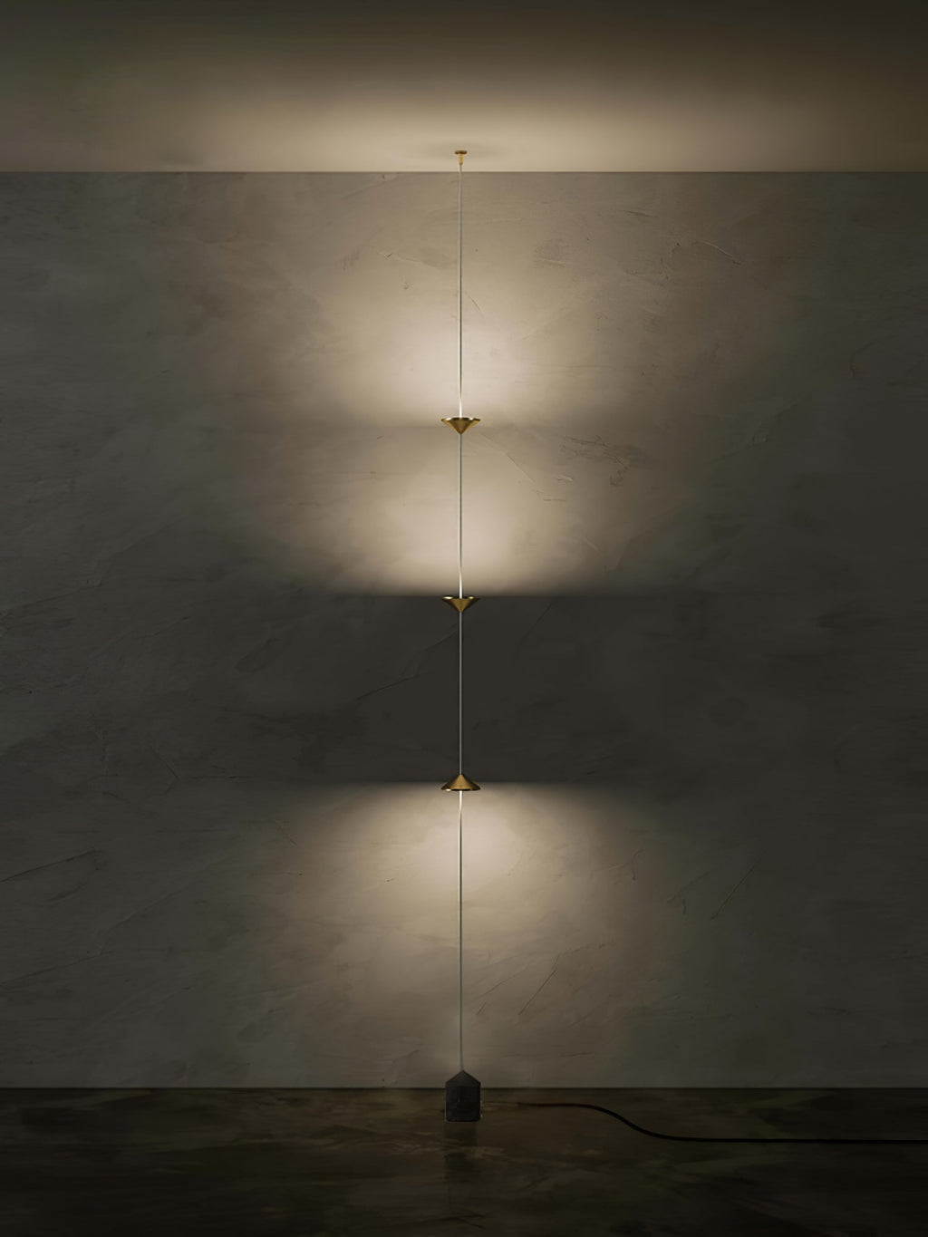 Floor lamp detail showing conical shade and slim black stem
