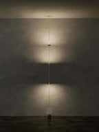 Floor lamp detail showing conical shade and slim black stem