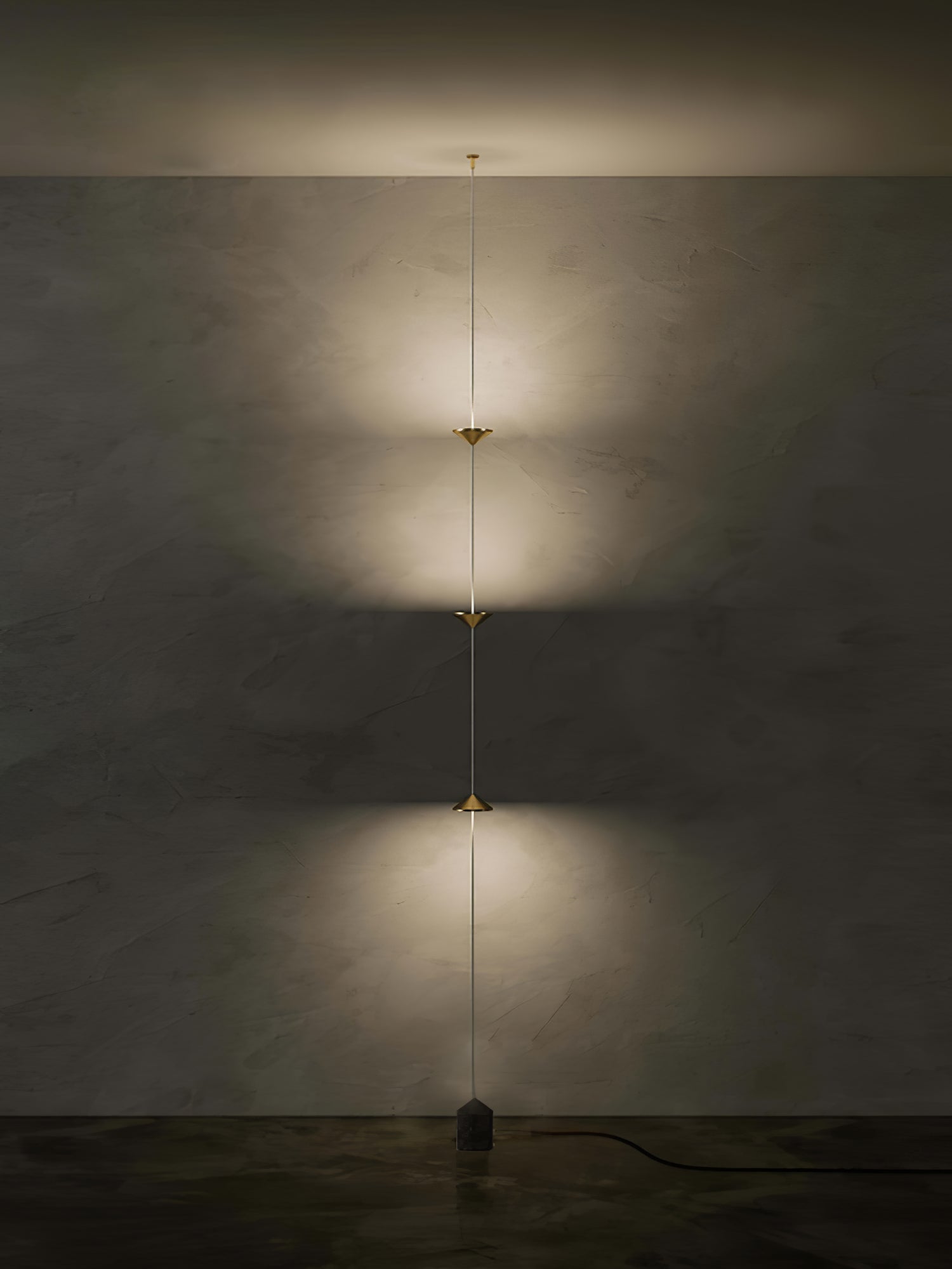Floor lamp detail showing conical shade and slim black stem