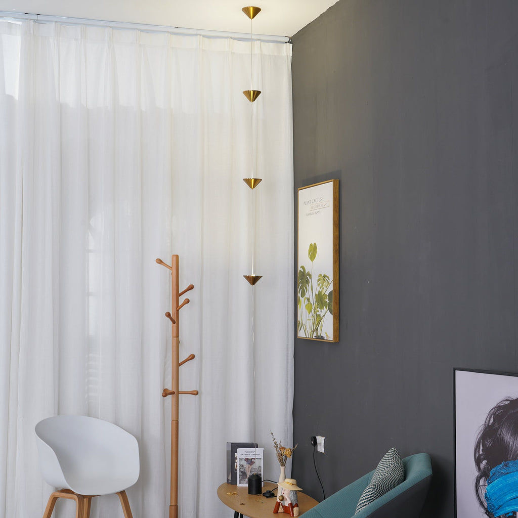 Floor lamp with gold shades beside furniture in a styled room