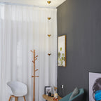 Floor lamp with gold shades beside furniture in a styled room