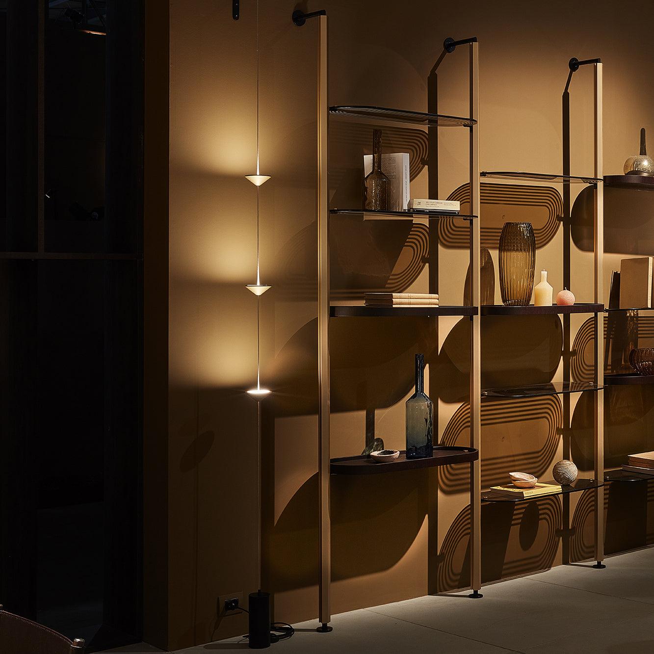 Floor lamp with warm glow beside a sofa in a living room