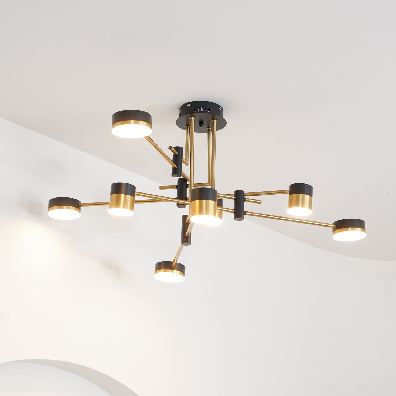 Spider chandelier with gold and black contrast in a styled interior