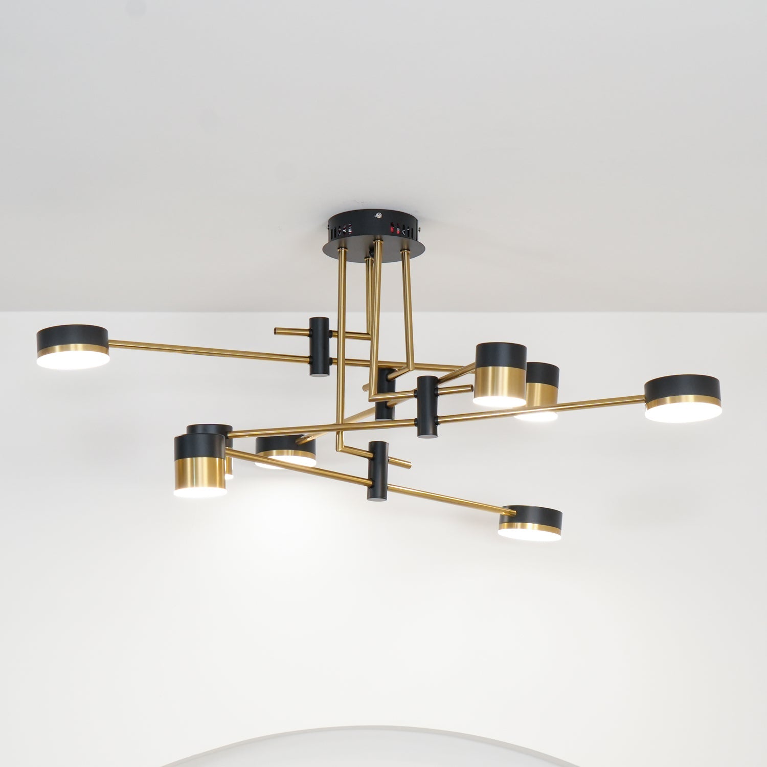 Spider chandelier sculptural form against a pale ceiling