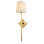 Lit on a plain white background, this Clérachic sconce's alabaster cone shade glows above a brushed brass diamond backplate.
