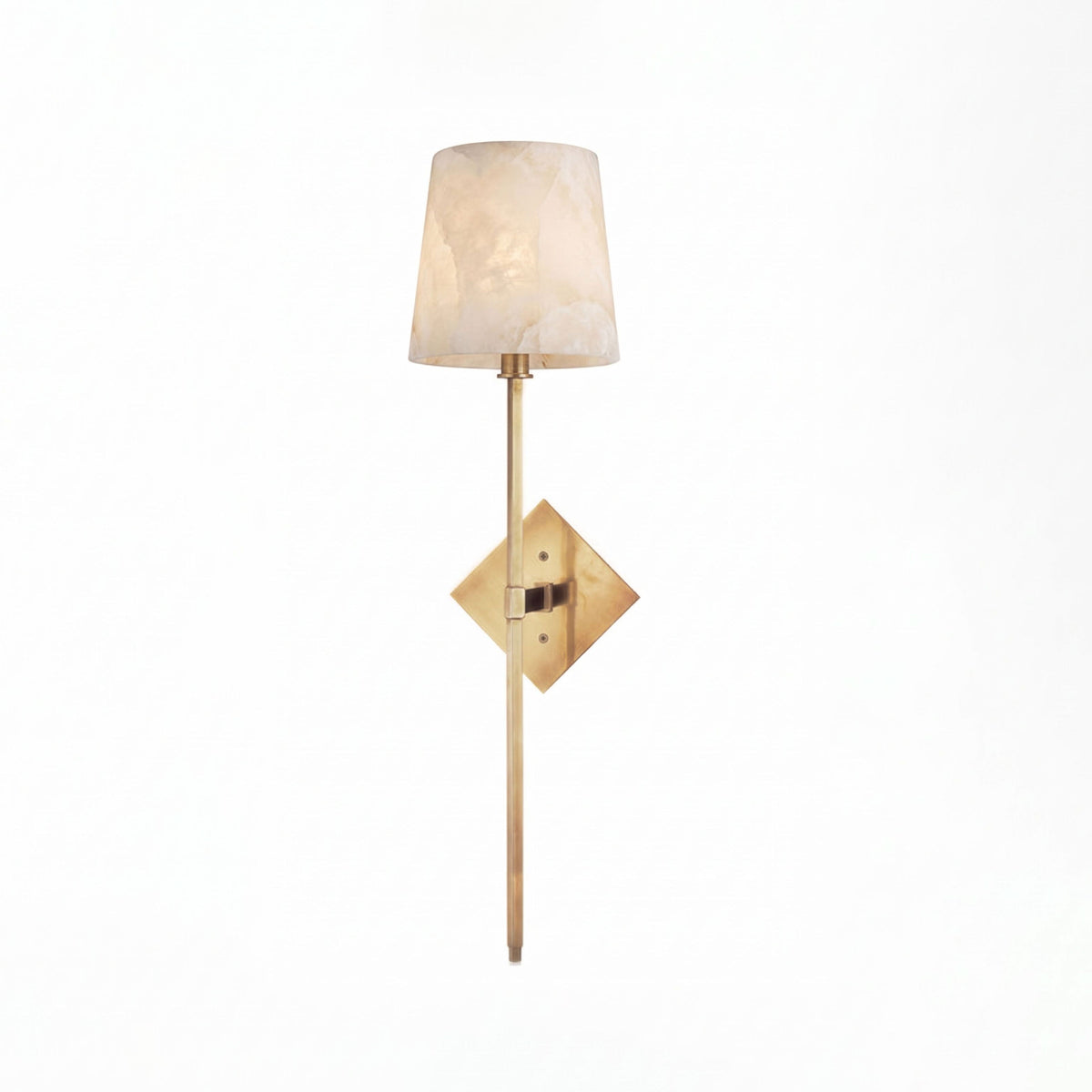 Lit on a plain white background, this Clérachic sconce's tall alabaster shade glows above its brushed brass diamond backplate.