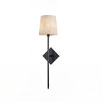 Unlit on a plain white background, this Clérachic sconce's matte black rod passes through a diamond-shaped backplate.