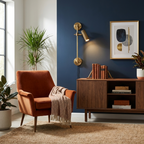 Against a dark blue wall, this Clérachic plug-in spotlight in bronze finish lights an armchair below it.
