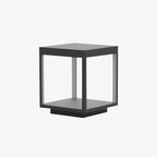 Square frame outdoor light lighting a garden path at night
