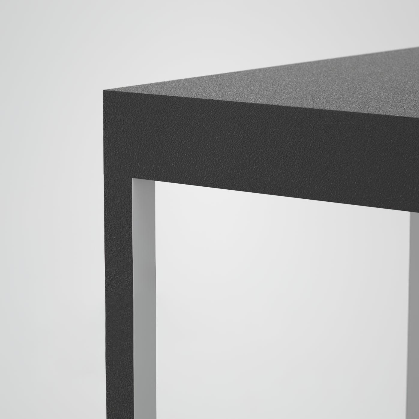Square stainless steel outdoor light glowing on a terrace