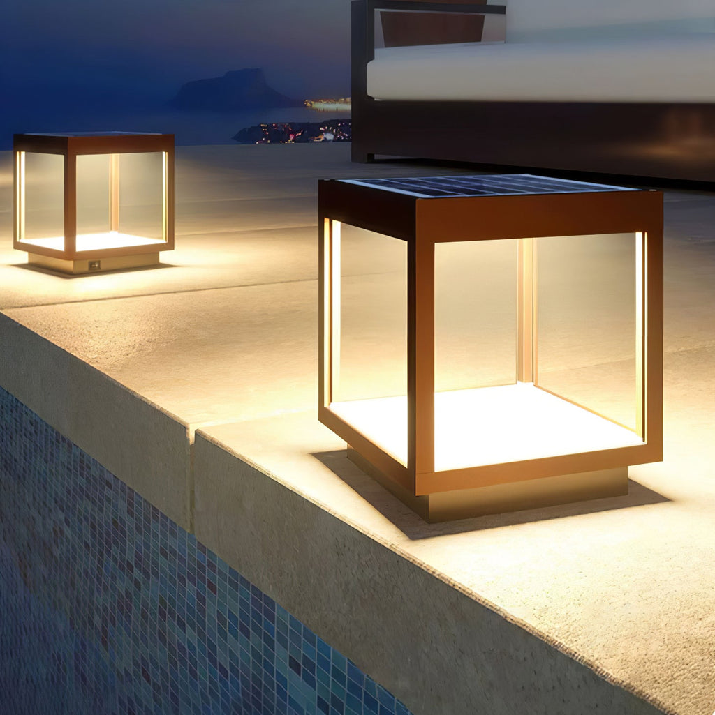 Square solar outdoor light with warm glow on a patio