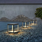 Solar outdoor post light casting light across garden beds