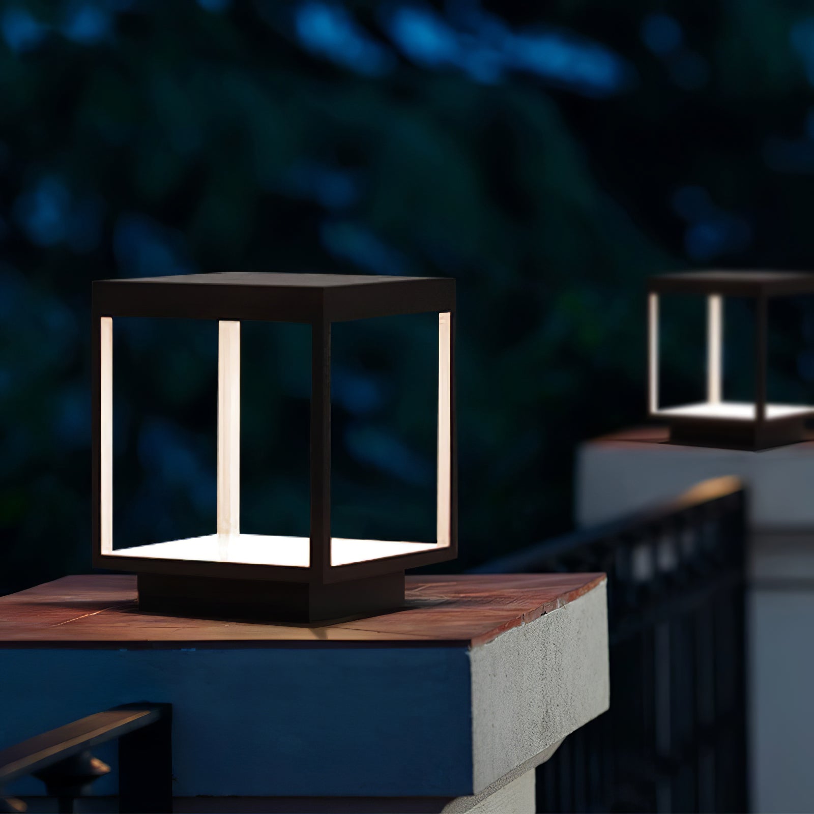 Solar outdoor post light lighting a garden corner at night