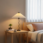 Squiggle table lamp viewed from the side with pleated shade
