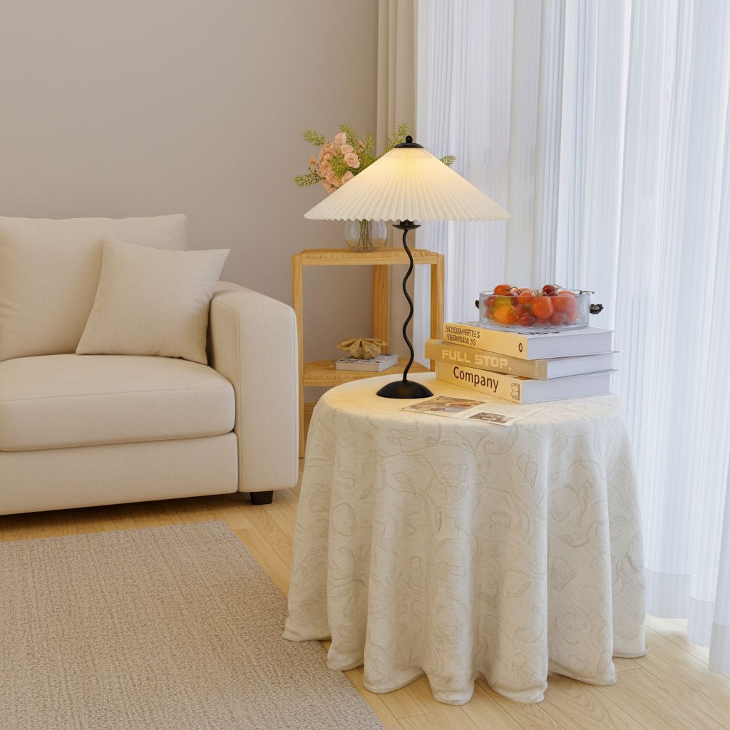 Squiggle table lamp on a bedside table casting warm light