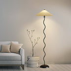 Squiggle floor lamp with black base curving up to a fabric shade