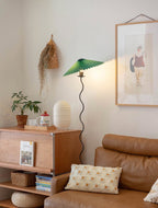 Squiggle floor lamp viewed from a low angle by a sofa