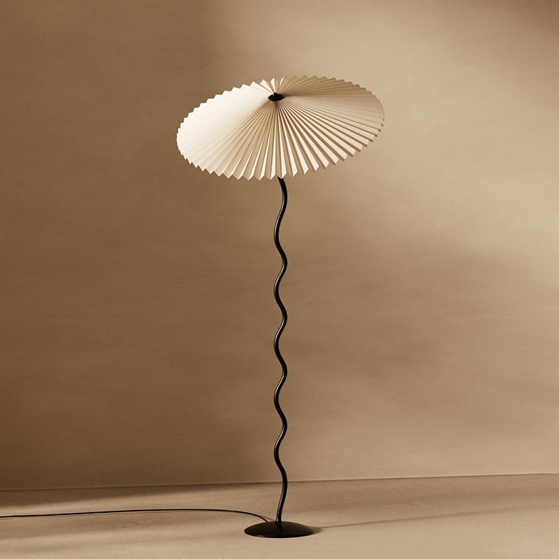Squiggle floor lamp standing tall in a decorated corner