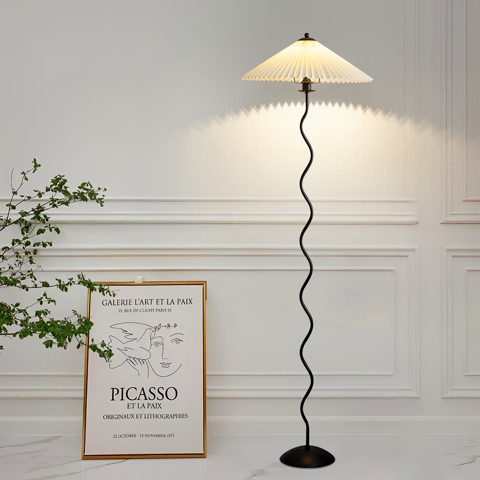Squiggle floor lamp lit beside seating in a cozy corner