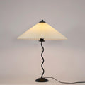 Squiggle table lamp with beige pleated shade and wavy black stem