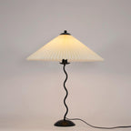 Squiggle table lamp with beige pleated shade and wavy black stem