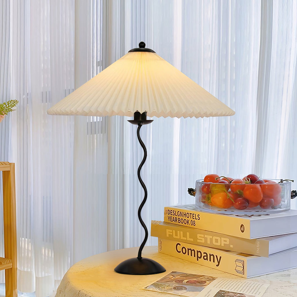 Squiggle table lamp glowing softly in a styled room