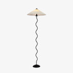 Squiggle floor lamp showing full silhouette against a wall