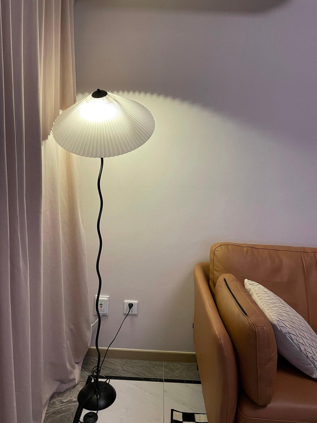Squiggle floor lamp with fabric shade in a warm interior