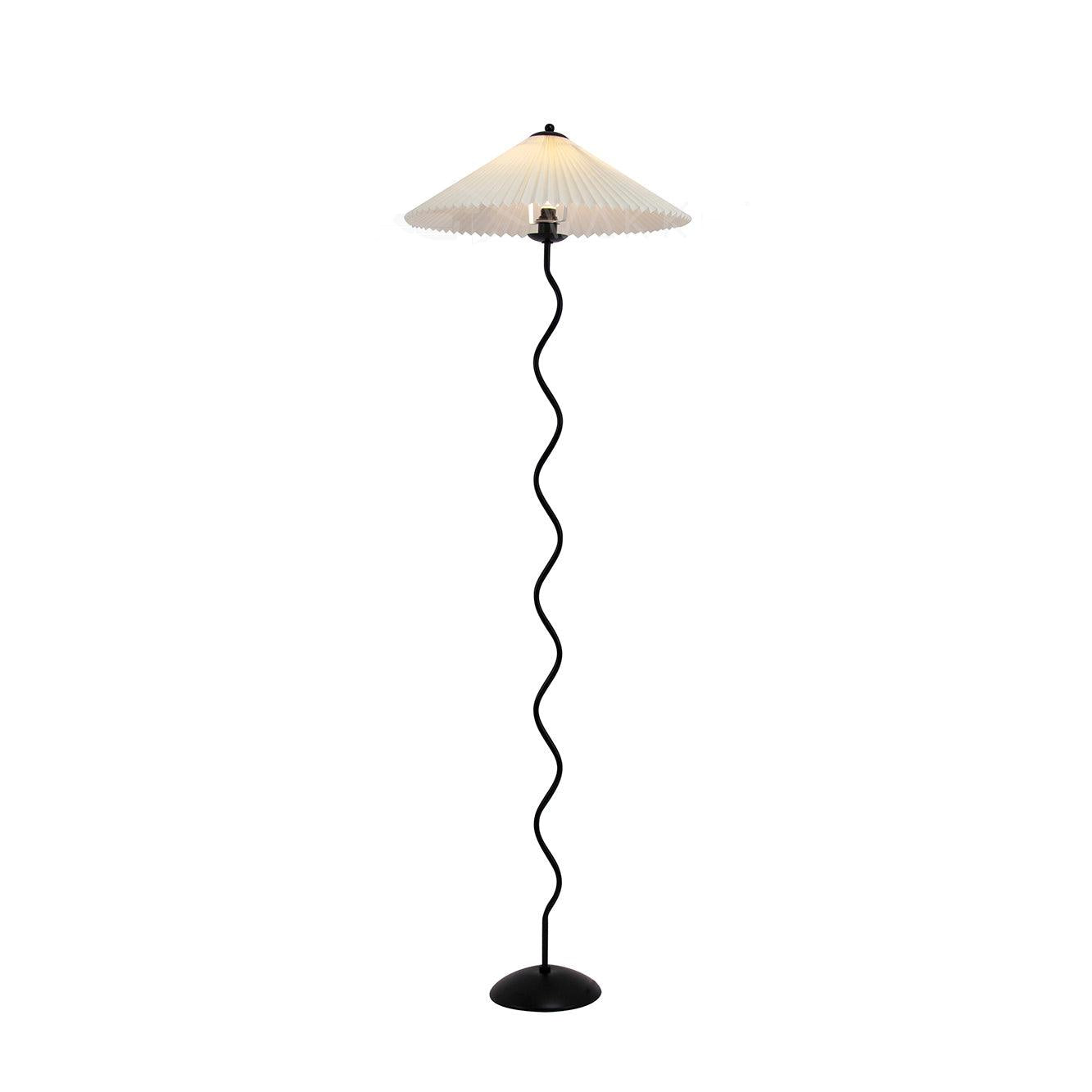 Squiggle floor lamp with wavy black base and fabric shade in a room corner