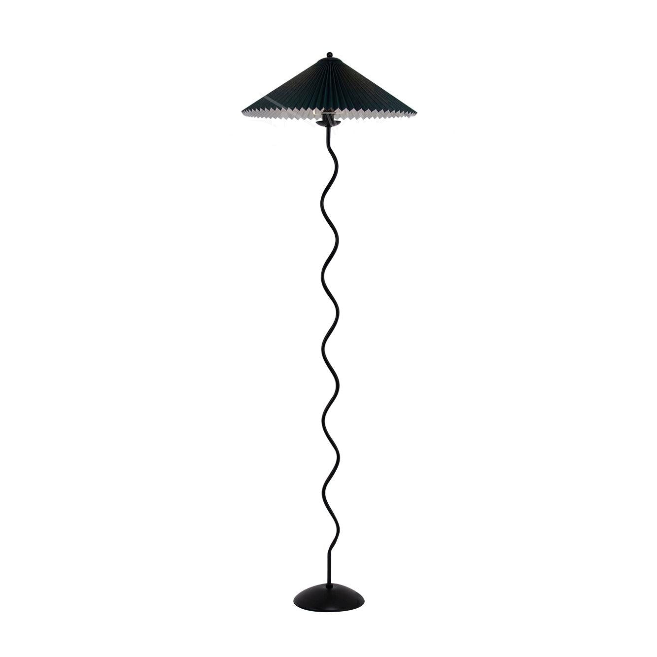 Wavy black metal base of the Squiggle floor lamp in close detail