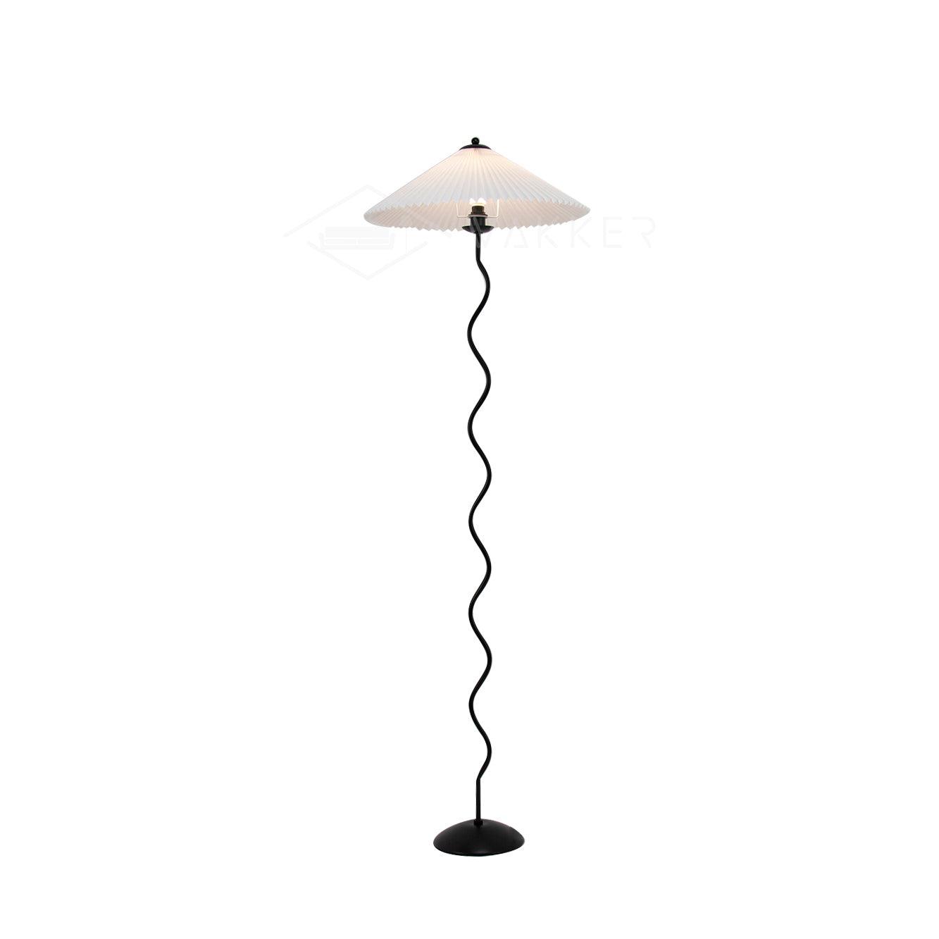Squiggle floor lamp glowing in a softly lit interior