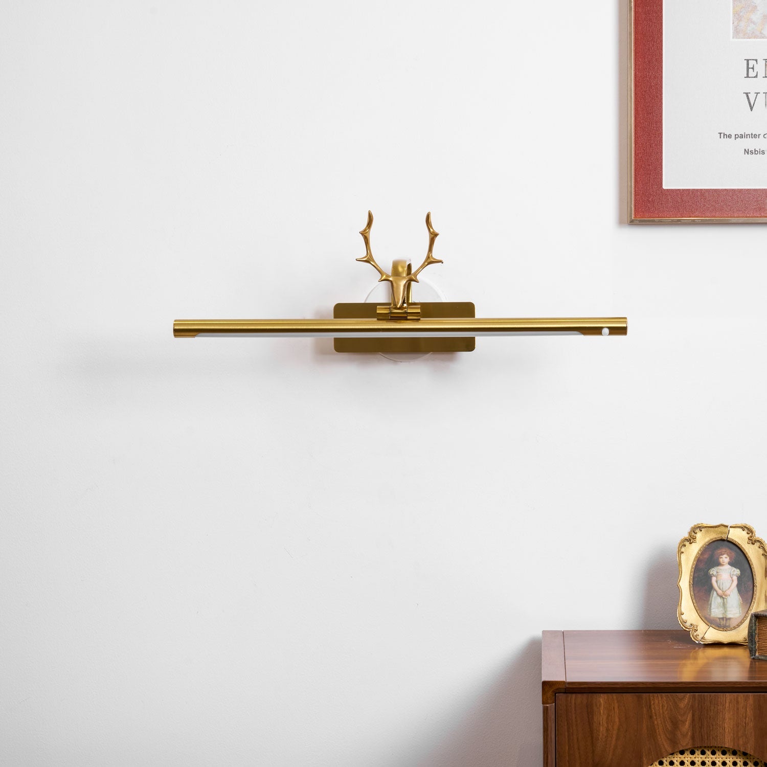 Wall sconce with curved stag horn detail and soft warm lighting