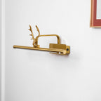 Stag horn wall light mounted neatly above a framed picture